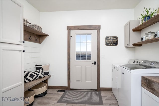 18287 Haasakker Rd, Three Forks, MT 59752 - laundry area with cabinet space, washing machine and clothes dryer, and light wood-style flooring