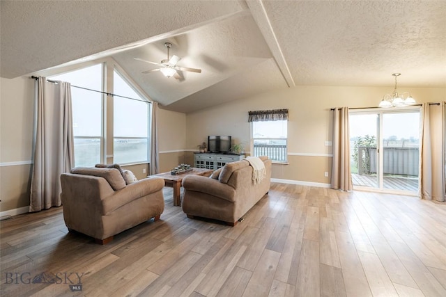 18287 Haasakker Rd, Three Forks, MT 59752 - living room with a textured ceiling, a chandelier, ceiling fan, light wood-style flooring, and lofted ceiling