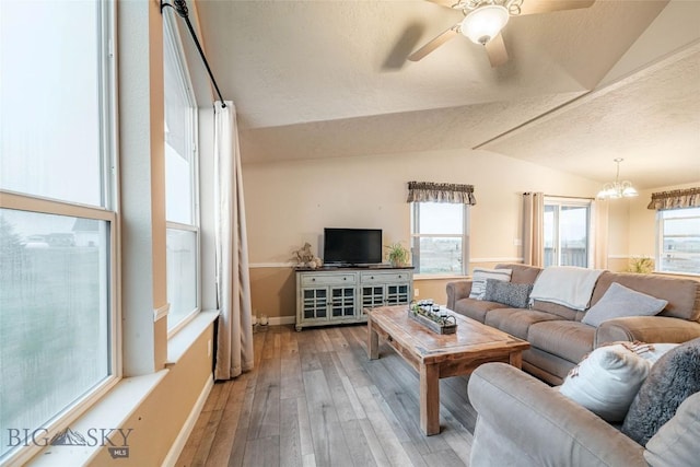 18287 Haasakker Rd, Three Forks, MT 59752 - living area with lofted ceiling, wood-type flooring, ceiling fan, a chandelier, and a textured ceiling