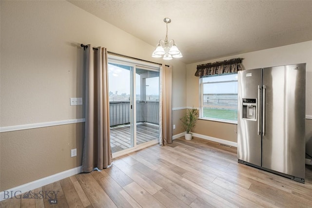18287 Haasakker Rd, Three Forks, MT 59752 - unfurnished dining area featuring a chandelier and light wood-style floors