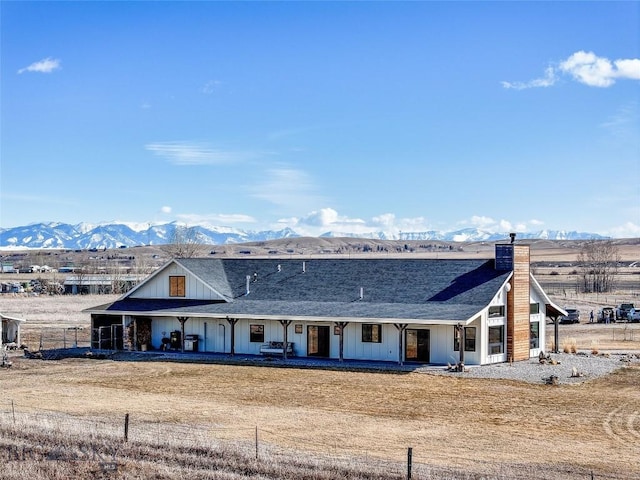18287 Haasakker Rd, Three Forks, MT 59752 - view of front of home featuring a mountain view, a chimney, board and batten siding, and roof with shingles