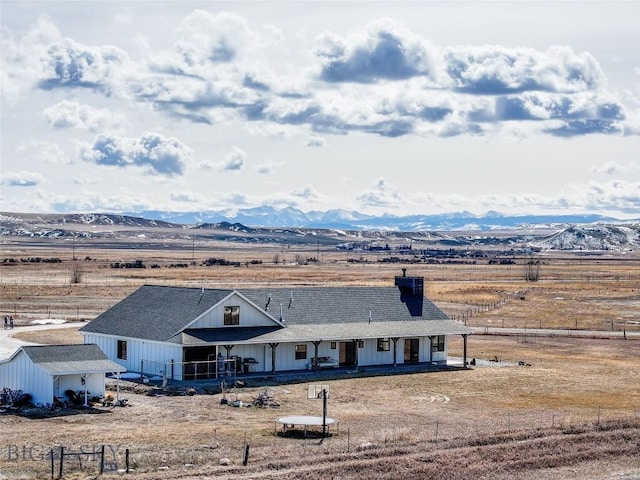 18287 Haasakker Rd, Three Forks, MT 59752 - back of property featuring a mountain view, a chimney, and a porch