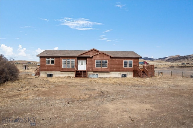 back of property featuring fence and a mountain view