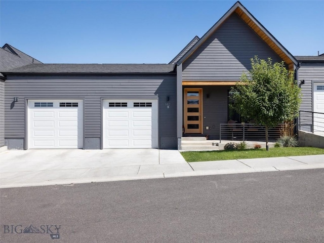 view of front of home featuring concrete driveway and a garage