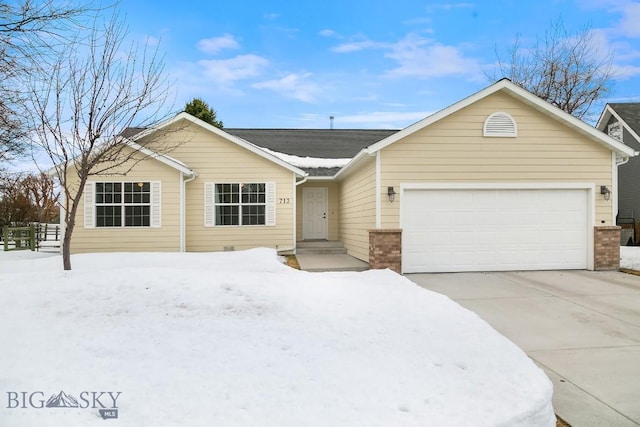 single story home featuring concrete driveway, an attached garage, and brick siding