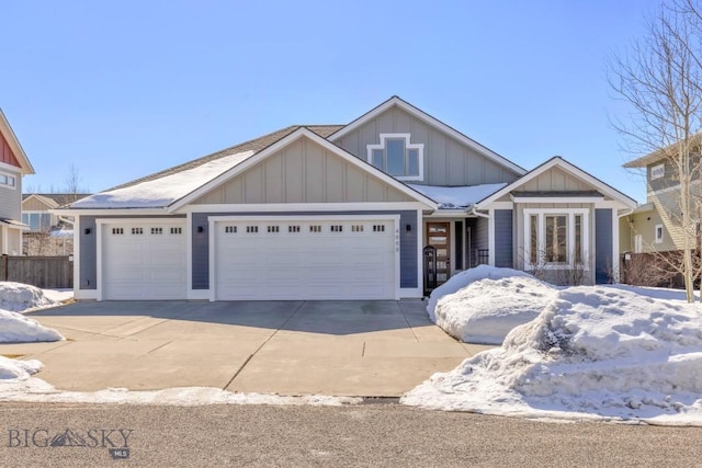 view of front of property with a garage, board and batten siding, concrete driveway, and fence