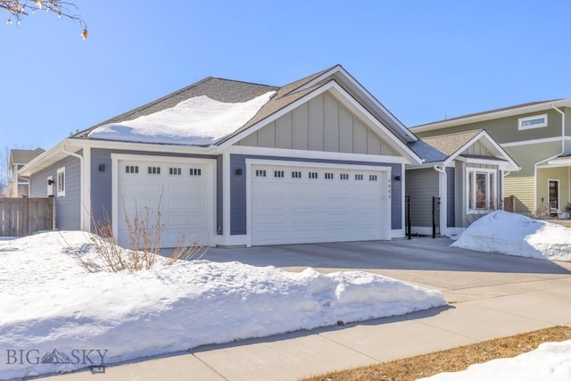 ranch-style home featuring board and batten siding, a garage, and fence