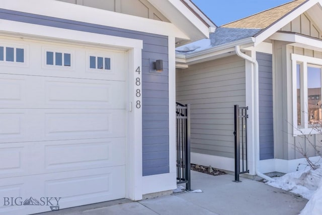 property entrance featuring a garage and roof with shingles