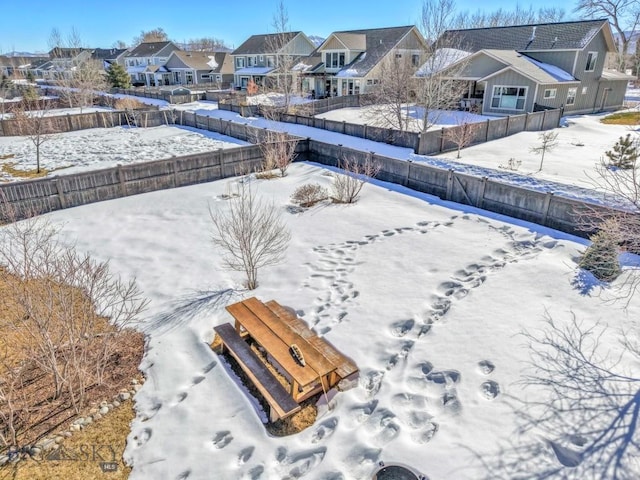 snowy aerial view featuring a residential view