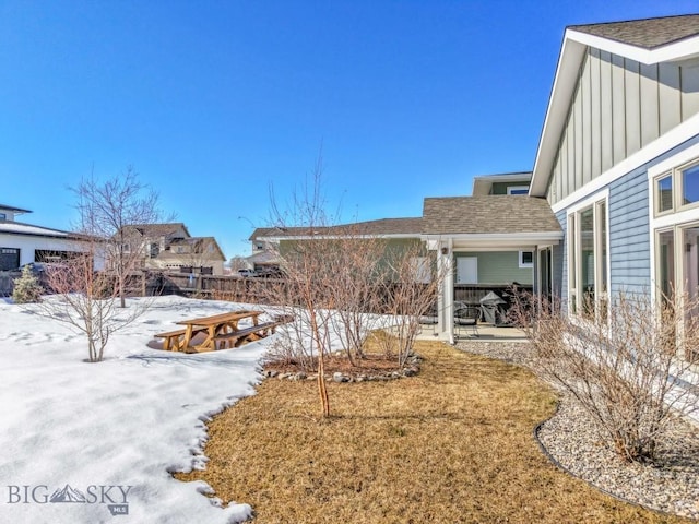 snowy yard with a patio