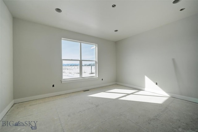 empty room featuring baseboards