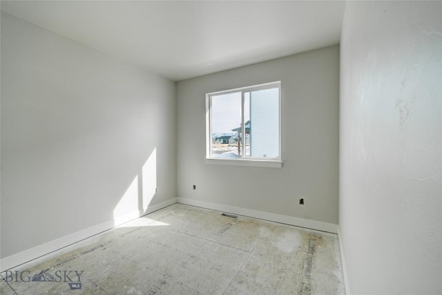 empty room featuring visible vents and baseboards