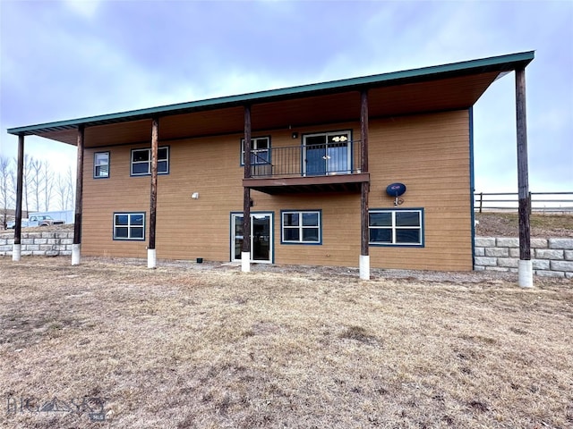 back of property with a balcony