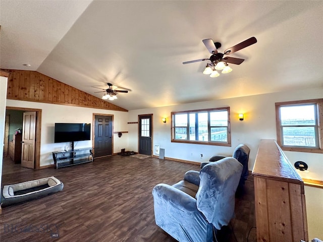 living room featuring a wealth of natural light, lofted ceiling, dark wood-type flooring, and ceiling fan