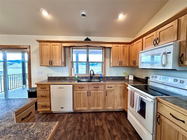 kitchen featuring a sink, dark countertops, dark wood-style floors, white appliances, and lofted ceiling