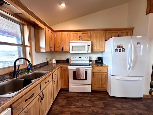 kitchen featuring dark countertops, a sink, lofted ceiling, white appliances, and dark wood-style flooring