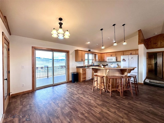 kitchen with a breakfast bar, white appliances, lofted ceiling, a chandelier, and dark wood-style flooring