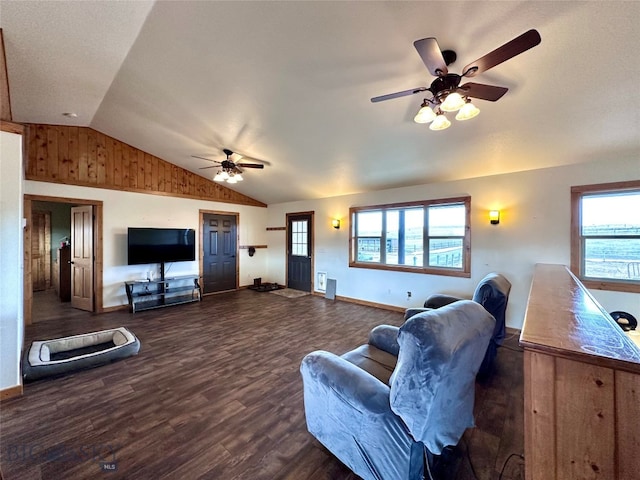 living room featuring a ceiling fan, vaulted ceiling, wood finished floors, and baseboards