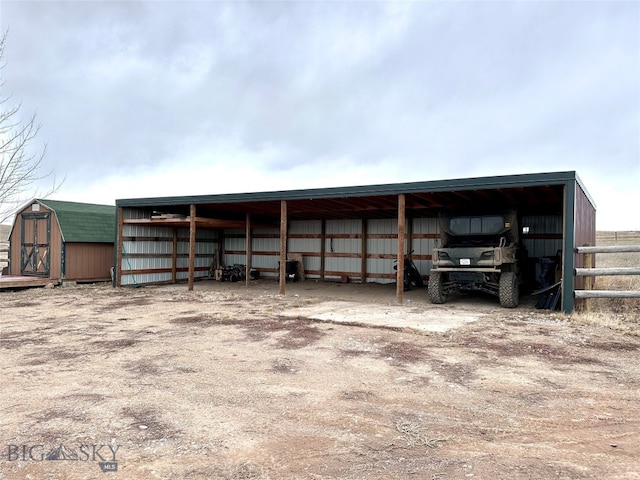 view of pole building with fence