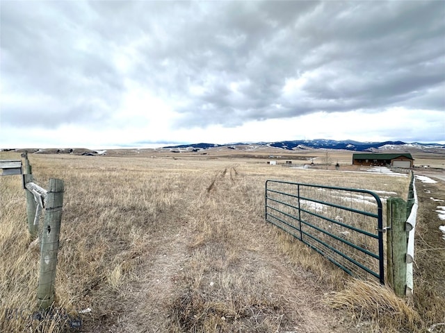 view of yard featuring a rural view and fence