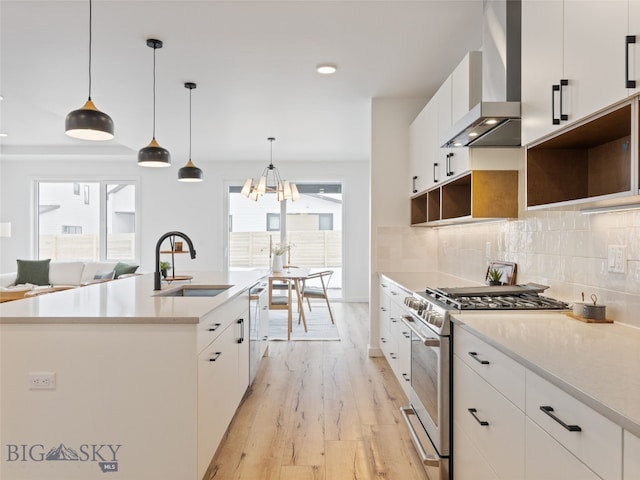 2824 S 30th Ave, Bozeman, MT 59718 - kitchen featuring a sink, wall chimney range hood, stainless steel gas stove, light wood-style flooring, and dishwashing machine