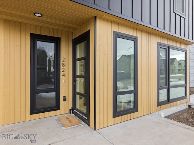 property entrance featuring board and batten siding