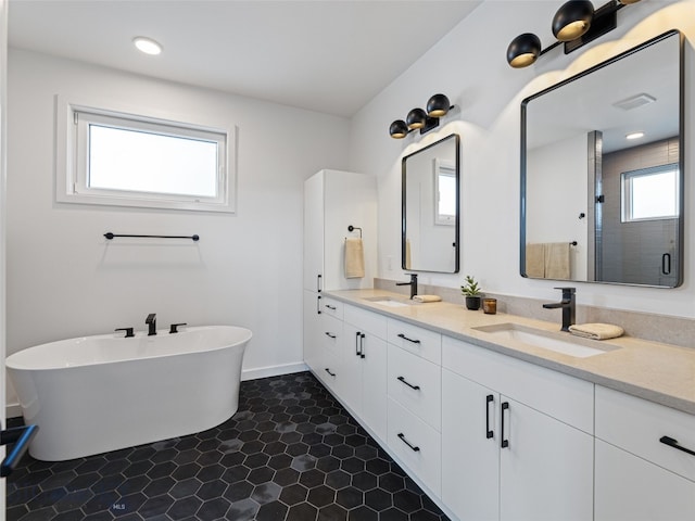 2824 S 30th Ave, Bozeman, MT 59718 - bathroom with double vanity, a freestanding tub, a stall shower, and baseboards