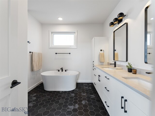 2824 S 30th Ave, Bozeman, MT 59718 - bathroom featuring double vanity, baseboards, and a soaking tub