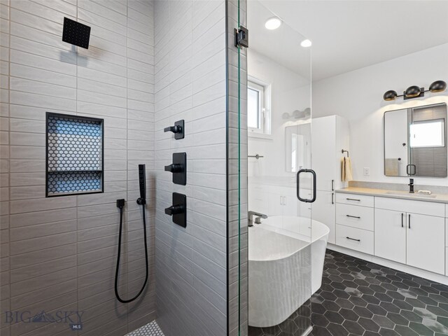 2824 S 30th Ave, Bozeman, MT 59718 - full bath featuring a stall shower, vanity, a freestanding tub, tile patterned floors, and recessed lighting