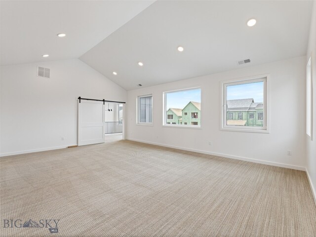2824 S 30th Ave, Bozeman, MT 59718 - unfurnished room with a barn door, light colored carpet, recessed lighting, lofted ceiling, and baseboards