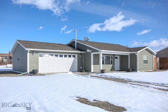 single story home featuring a garage and fence