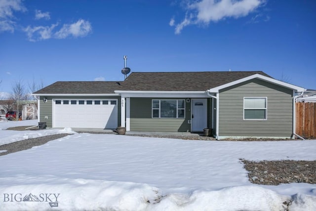 ranch-style home with an attached garage and fence