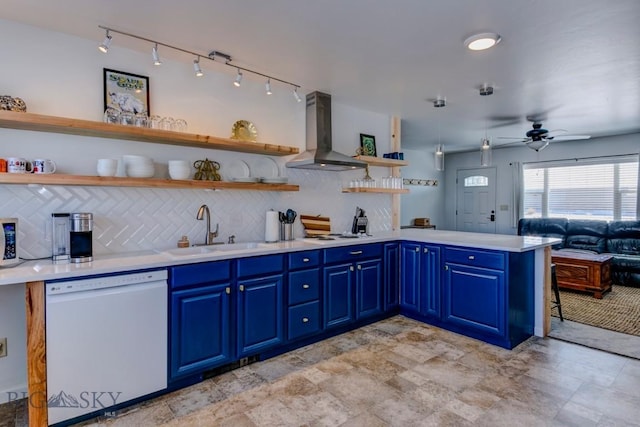 kitchen featuring a sink, open shelves, blue cabinetry, range hood, and white appliances