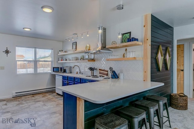 kitchen featuring stainless steel microwave, open shelves, wall chimney exhaust hood, and a baseboard radiator