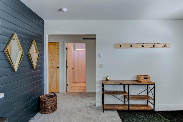 interior space with carpet floors and wood walls