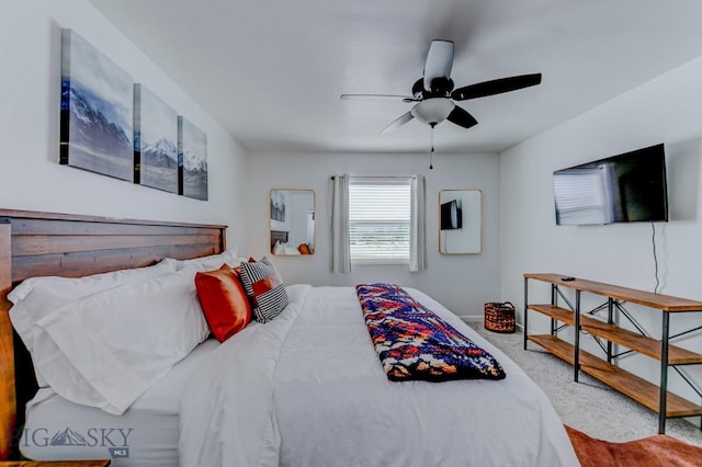 bedroom with a ceiling fan, carpet, and baseboards