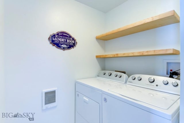 washroom with laundry area, visible vents, and washer and clothes dryer