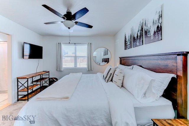 bedroom featuring a ceiling fan, ensuite bath, and carpet