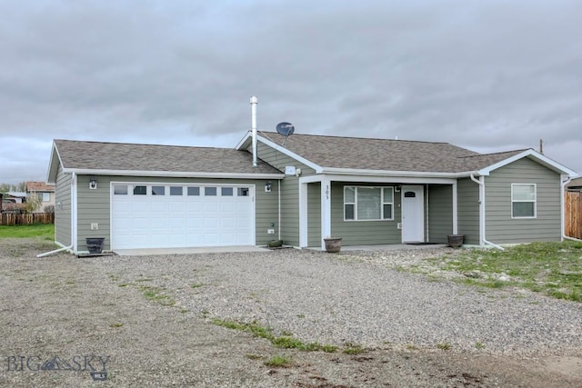 305 Lathrop St W, Clyde Park, MT 59018 - single story home featuring an attached garage, driveway, roof with shingles, and fence