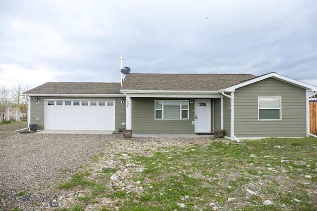 305 Lathrop St W, Clyde Park, MT 59018 - single story home with a garage, gravel driveway, and a shingled roof