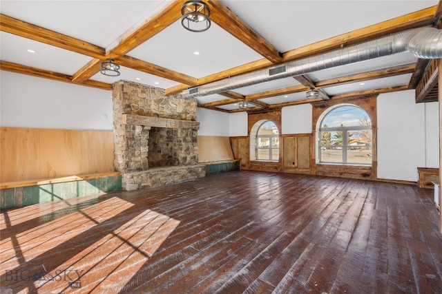 8005 Churchill Rd, Churchill, MT 59741 - unfurnished living room featuring a stone fireplace, a wainscoted wall, beamed ceiling, coffered ceiling, and hardwood / wood-style flooring