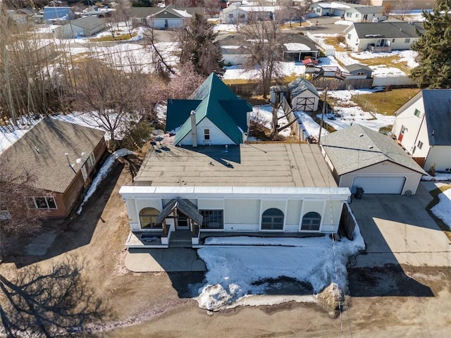 snowy aerial view with a residential view