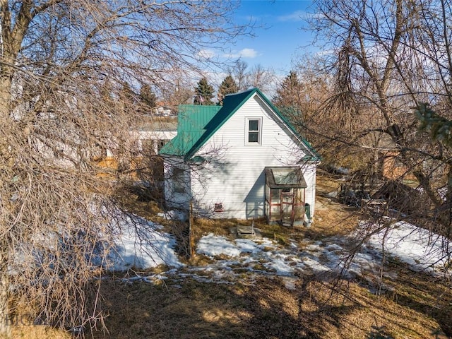 view of property exterior featuring metal roof