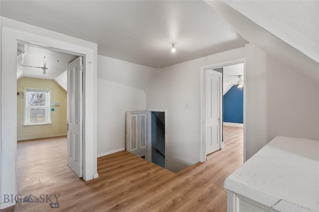 additional living space with light wood-type flooring and lofted ceiling