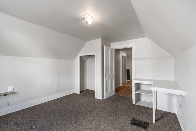 bonus room with visible vents, lofted ceiling, and carpet