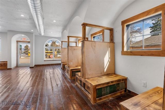 interior space with recessed lighting, baseboards, dark wood-style flooring, and arched walkways