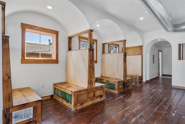 corridor featuring recessed lighting, visible vents, wood-type flooring, and baseboards