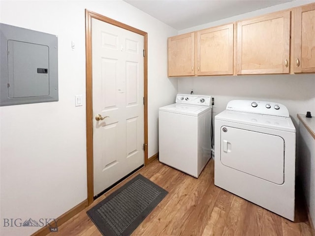 washroom with separate washer and dryer, electric panel, cabinet space, and light wood-type flooring