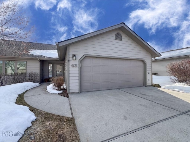 view of front of property with a garage and concrete driveway