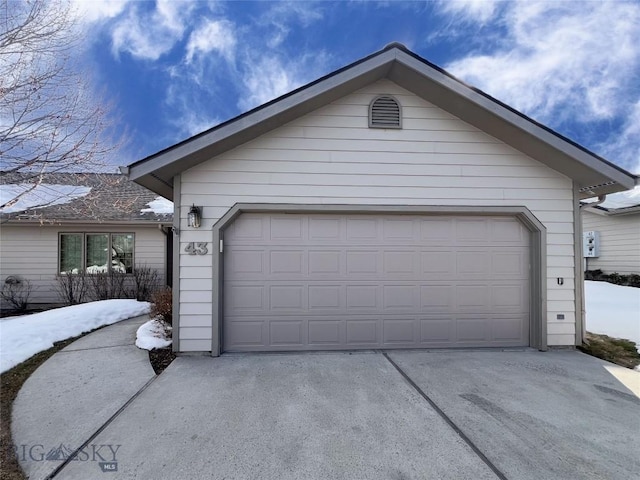 garage featuring concrete driveway